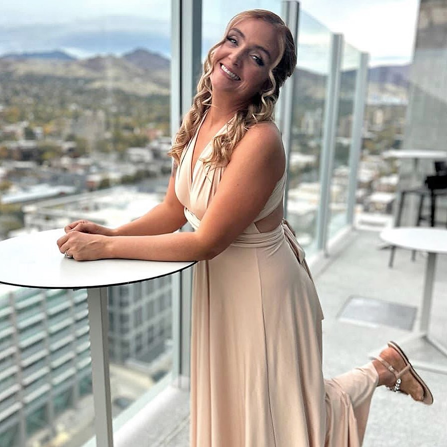 Bridal client in champagne gown with soft glam by MakeupByGen overlooking Salt Lake City